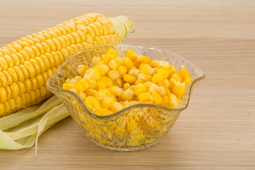 Sweet corn in a bowl on wooden background photo