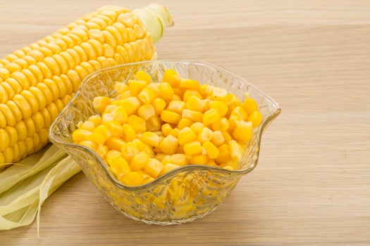 Sweet corn in a bowl on wooden background photo