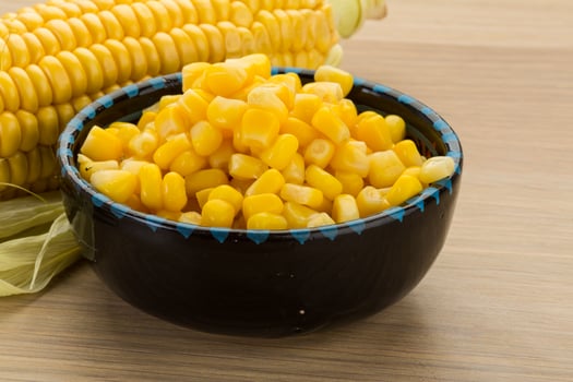 Sweet corn in a bowl on wooden background photo