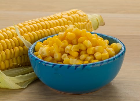 Sweet corn in a bowl on wooden background photo