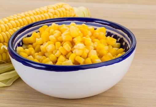 Sweet corn in a bowl on wooden background photo