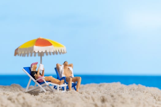 Miniature people Happy family relaxing on The beach photo