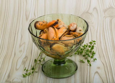 Mussels in a bowl on wooden background photo