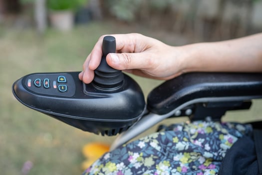 Asian lady woman patient on electric wheelchair with joystick and remote control at nursing hospital ward, healthy strong medical concept photo