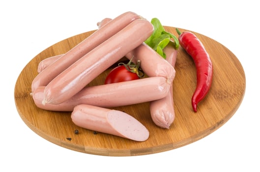 Sausages on wooden board and white background photo
