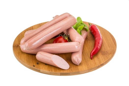 Sausages on wooden board and white background photo
