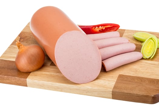 Sausages on wooden board and white background photo