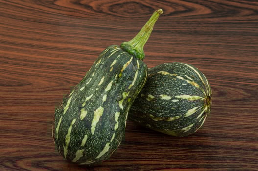 Green pumpkin on wooden background photo