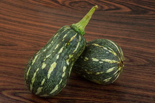Green pumpkin on wooden background photo