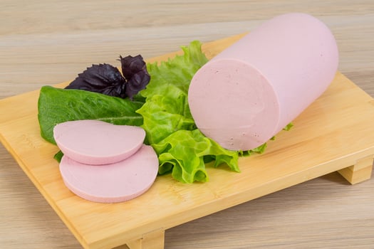 Sausage on wooden board and wooden background photo
