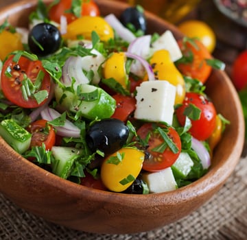 Greek salad with fresh vegetables, feta cheese and black olives photo