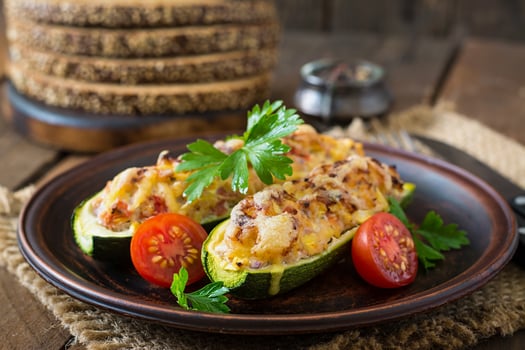 Stuffed zucchini with chicken, tomatoes and onion with cheese crust photo