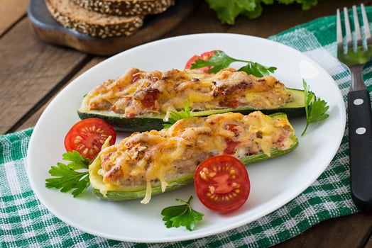 Stuffed zucchini with chicken, tomatoes and onion with cheese crust photo