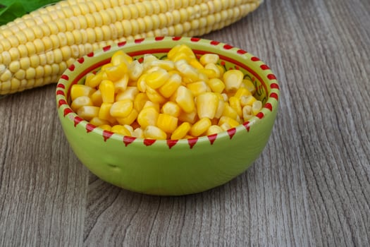 Sweet corn in a bowl on wooden background photo