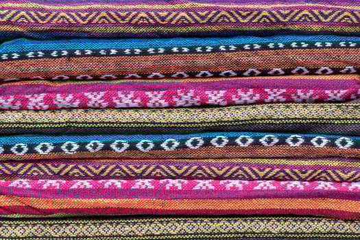 Folded colorful patterned scarves. photo