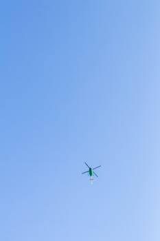 Green helicopter in the sky. photo