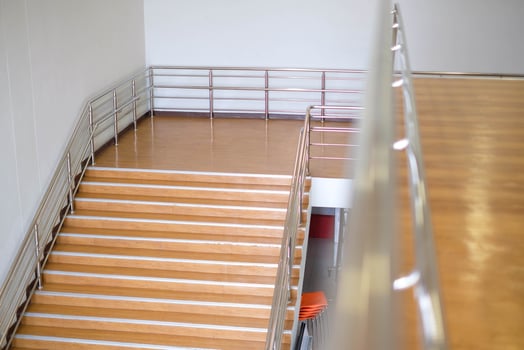 Modern brown staircase, walkway up the building building, aluminum steel railing photo