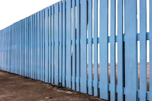Side view, old wooden fence painted in beautiful blue color. photo