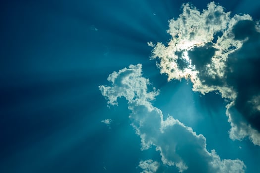 Background of a landscape of clouds with sunlight shining through. photo