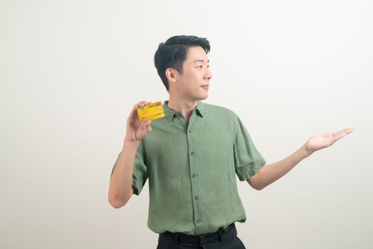 young Asian man holding credit card photo