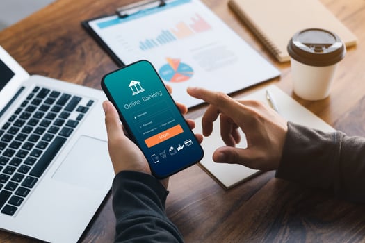 Male executive using smartphone to conduct online mobile banking, investing in stocks and mutual funds, retirement investment ideas. photo