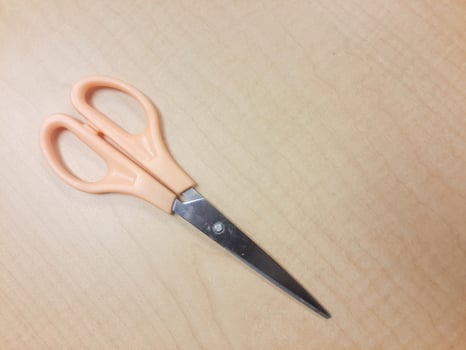 The scissors stationary on the table. Shot from above, Top view. photo