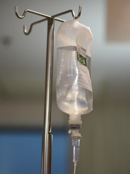 Set IV saline bottle solution Fluid filled in pediatric patient hand in the hospital photo