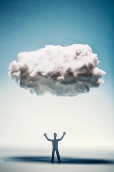 Angry man with clenched fists standing under a cloud. photo