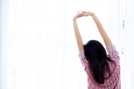 Beautiful of portrait young asian woman stretch and relax in bed after wake up morning at bedroom, new day and resting for wellness, back view, lifestyle concept. photo