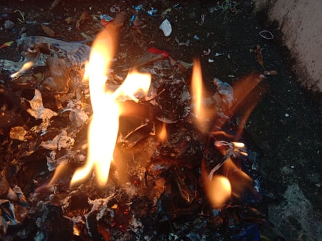 A burning trash pile with flames photo