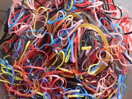 A bowl full of colorful rubber bands photo