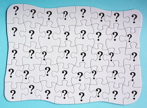 Set of 40 puzzle pieces with question mark isolated on blue background. photo