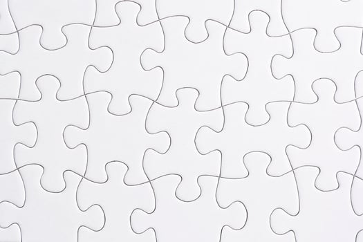 Puzzle pieces isolated on blue background. Flat lay. Directly above. photo