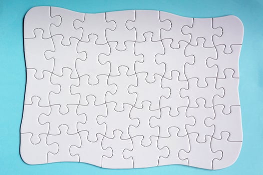 Set of 40 puzzle pieces isolated on blue background. Flat lay. Directly above. photo