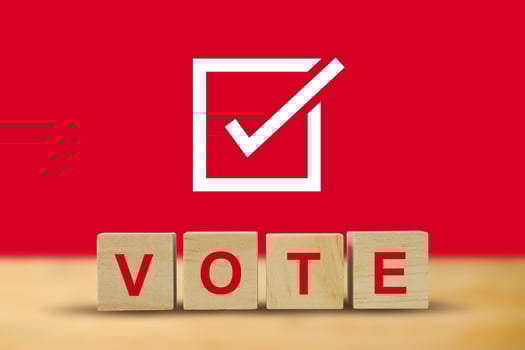 Vote on word letters cube, hand putting voting paper in the ballot box ,  illustration. photo