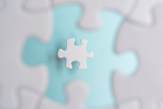 Puzzle pieces isolated on blurred blue background. Flat lay. Directly above. photo