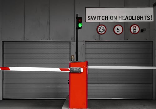 Subterranean parking garage entry gate with switch on headlights sign photo