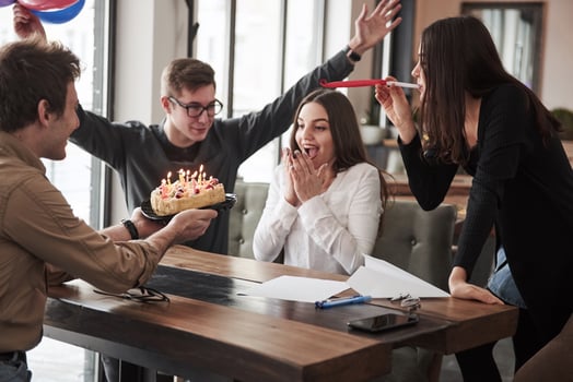 Surprise for the beautiful brunette. One of employees have birthday today. Friendly coworkers decides to make surprise for her photo