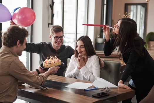 Cake and balloons. One of employees have birthday today. Friendly coworkers decides to make surprise for her photo