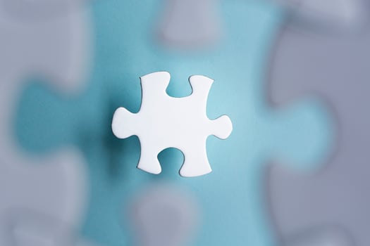 Puzzle pieces isolated on blurred blue background. Flat lay. Directly above. photo