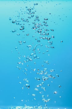 Abstract background image of bubbles in water. Clean water with water droplets and waves. Fresh water a glass with bubbles blue background. photo