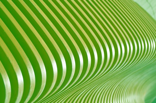Beautifully curved wooden green slats. Smooth abstract lines as a background. Element of finishing the facade of the building. photo