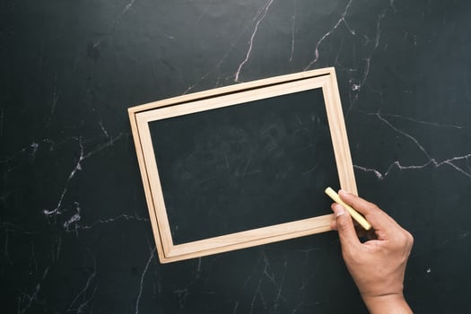 colorful chalk and chalkboard on black background photo