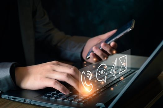 Concept of business communication. Businessman using computer and smartphone to contact customers via online internet, meeting, global network, shape icon phone email mail message on virtual screen. photo