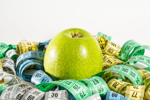 Apple and measuring tape, Diet. photo