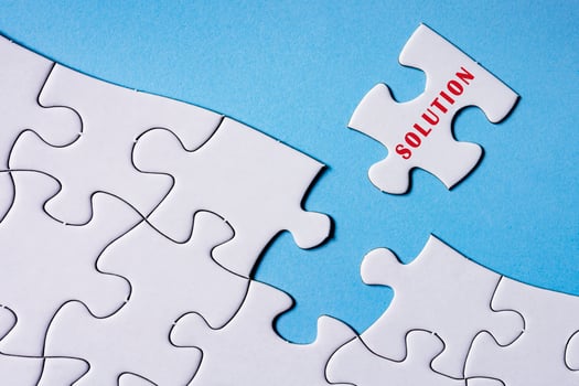 White jigsaw puzzle with word solution over blue background. photo