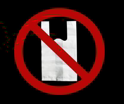Department store say no plastic bags. No plastic bags campaign. Environment day concept. Environment pollution from plastic bag concept. White plastic bag in red forbidden symbol on black background. photo