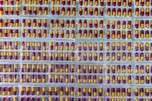 Antibiotic capsule pills in blister pack at production line of pharmaceutical manufacturing factory. Pharmaceutical industry and pharmaceutics concept. Antibiotic drug resistance. Pills packaging. photo