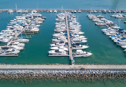 Marine port for yacht, motorboat, sailboat parking service and moorings for luxury and wealthy millionaire in aerial view with many ships anchoring along the dock bay photo