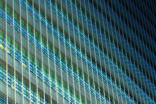 Modern futuristic glass building abstract background. Exterior of office glass building architecture. Facade of sustainable business building. Energy saving architecture. Glass window of company. photo